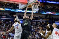 New Orleans Pelicans forward Larry Nance Jr. (22) dunks against Los Angeles Clippers forward Paul George (13) during the second half of an NBA basketball game in New Orleans, Friday, March 15, 2024. (AP Photo/Matthew Hinton)