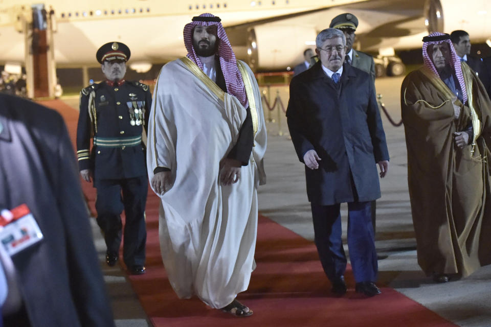 Saudi Crown Prince Mohammed bin Salman, left, is greeted by Algerian Prime Minister Ahmed Ouyahia upon his arrival at Algiers international airport, Algeria, Sunday, Dec. 2, 2018. Algeria's presidency says Saudi Crown Prince Mohammed bin Salman will start a two-day visit to Algeria Sunday with a focus on economic ties between the two countries. (AP Photo/Anis Belghoul)