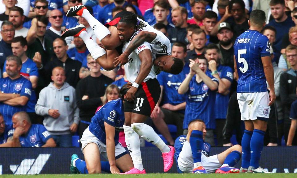 <span>Adama Traoré celebrates hitting Fulham’s equaliser by giving teammate Rodrigo Muniz a lift.</span><span>Photograph: Cat Goryn/Action Images/Reuters</span>