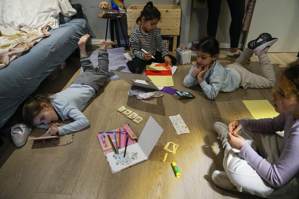 Israeli girls, evacuated from Kiryat Shmona, play in a room in the hotel in Tiberias, northern Israel, Monday, March 4, 2024. Around 60,000 Israelis who evacuated from cities and towns along the border with Lebanon are grappling with the question of when they will be able to return home. Hezbollah began launching rockets towards Israel one day after Hamas-led militants stormed into southern Israel on Oct. 7. (AP Photo/Ariel Schalit)