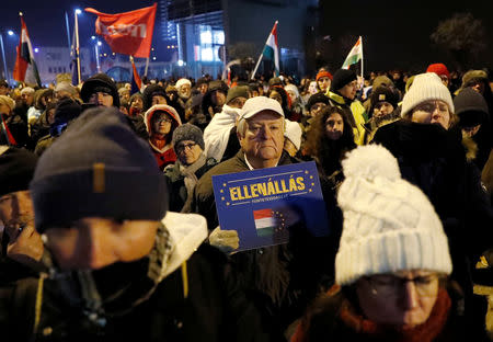 Demonstrators are seen outside the headquarters of the Hungarian state television during a protest against a proposed new labor law, billed as the "slave law", in Budapest, Hungary, December 17, 2018. The placard reads "Resistance". REUTERS/Bernadett Szabo