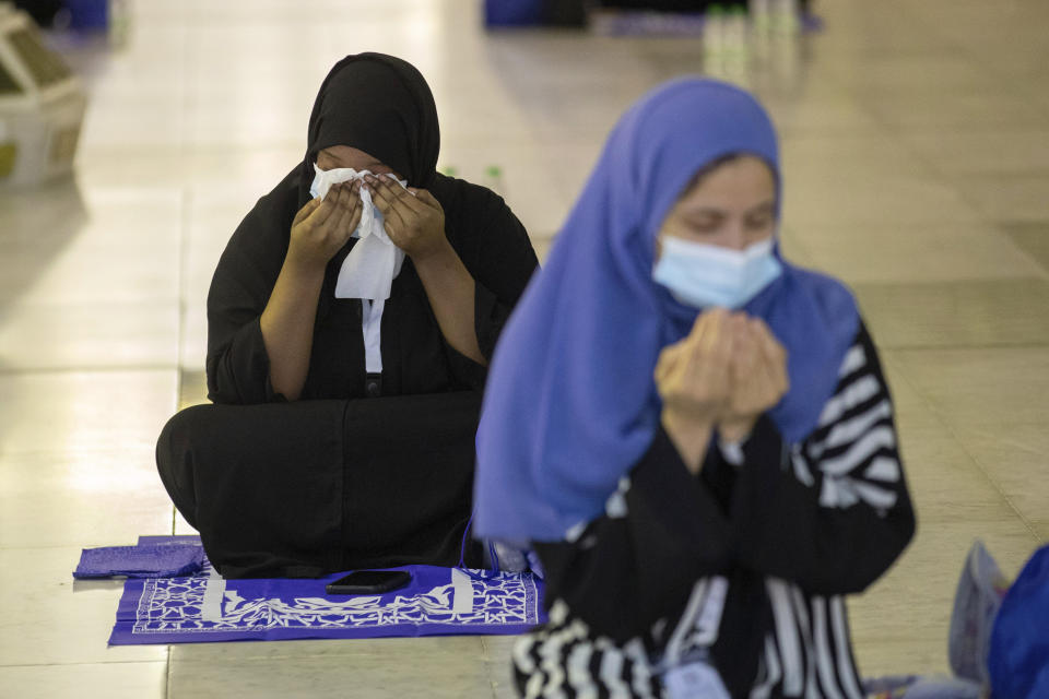 In this photo released by the Saudi Media Ministry, a limited numbers of pilgrims pray in the first rituals of the hajj, as they keep social distancing to limit exposure and the potential transmission of the coronavirus, at the Grand Mosque in the Muslim holy city of Mecca, Saudi Arabia, Wednesday, July 29, 2020. A unique and scaled-down hajj started on Wednesday. (Saudi Media Ministry via AP)