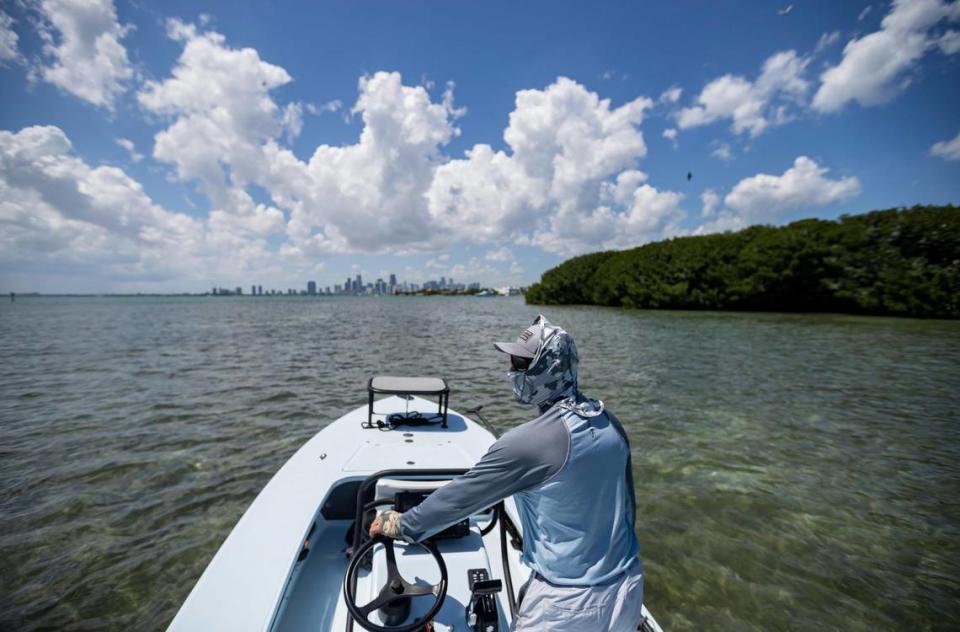 Fishing guide Carl Ball, 58, drives his boat near Crandon Park Marina on Saturday, April 22, 2023, in Key Biscayne, Fla. MATIAS J. OCNER/mocner@miamiherald.com