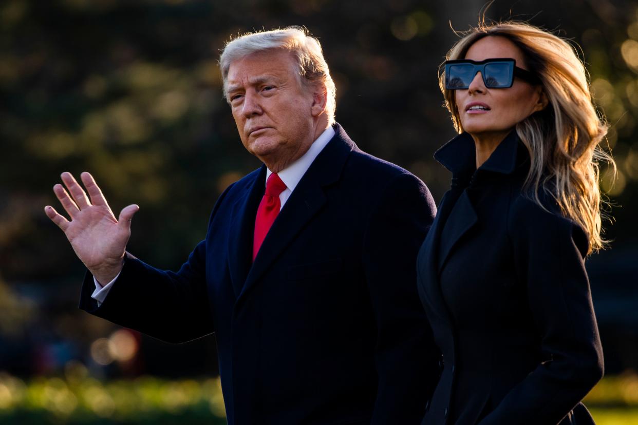 President Donald Trump and First Lady Melania Trump walk towards Marine One as they depart the White House en route to Mar-a-Lago, the President's private club, where they will spend Christmas and New Years Eve in Washington, DC on December 23, 2020. - President Donald Trump has thrown a long-awaited pandemic relief package into doubt days before millions of Americans will lose their benefits and face eviction from their homes. (Photo by Samuel Corum / AFP) (Photo by SAMUEL CORUM/AFP via Getty Images)