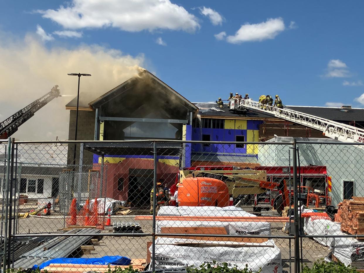 Mansfield firefighters battled a fire on the roof of the new addition to Westbrook Country Club on Tuesday afternoon.