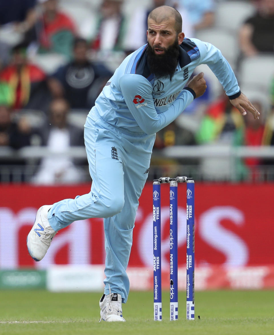 FILE - In this file photo dated Tuesday, June 18, 2019, England's Moeen Ali bowls during the Cricket World Cup match between England and Afghanistan at Old Trafford in Manchester, England. A four-match test series between England and India begins Friday Feb. 5, 2021, with England’s spin bowlers including Leach facing off against an intimidating Indian batting lineup featuring Virat Kohli, who is available again. (AP Photo/Rui Vieira, FILE)