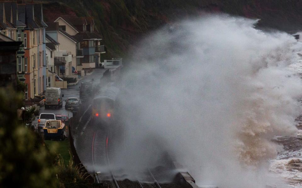 The customary photo of a wave hitting the rails at Dawlish - SWNS