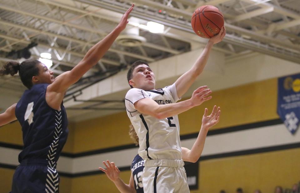 South Side's Brody Almashy (2) goes for a layup after getting around Rochester's Nathan Bills (13) during the first half Friday night at South Side High School.