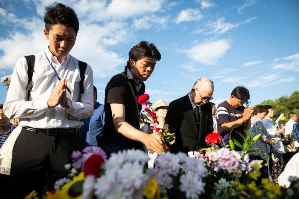 Visitors lays flowers and pray