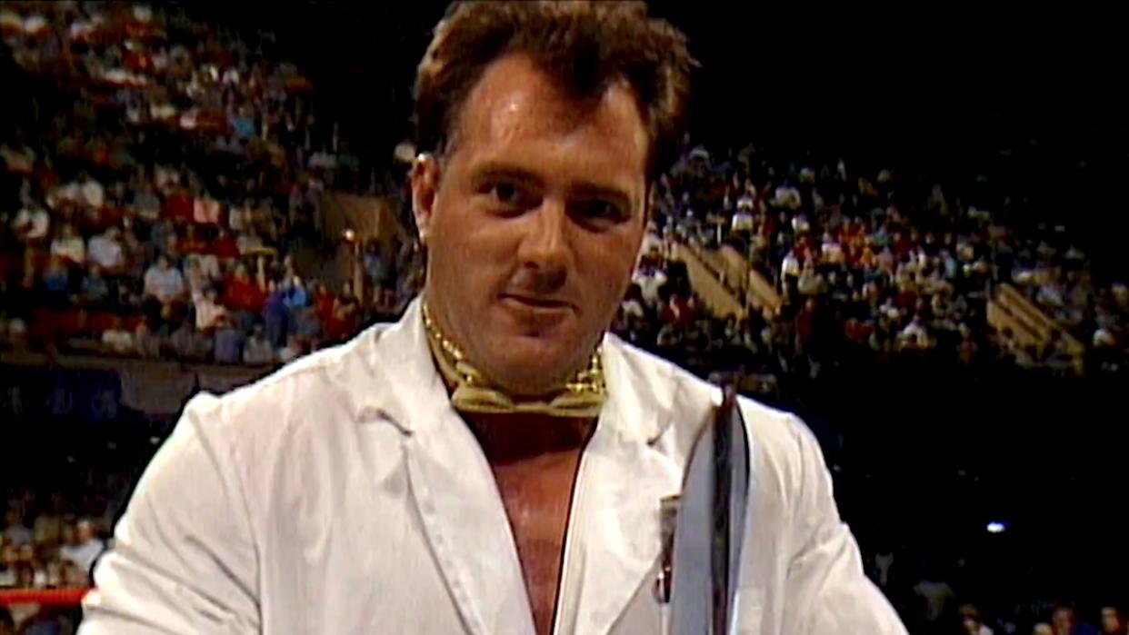  Brutus the Barber Beefcake holding giant scissors in WWE. 