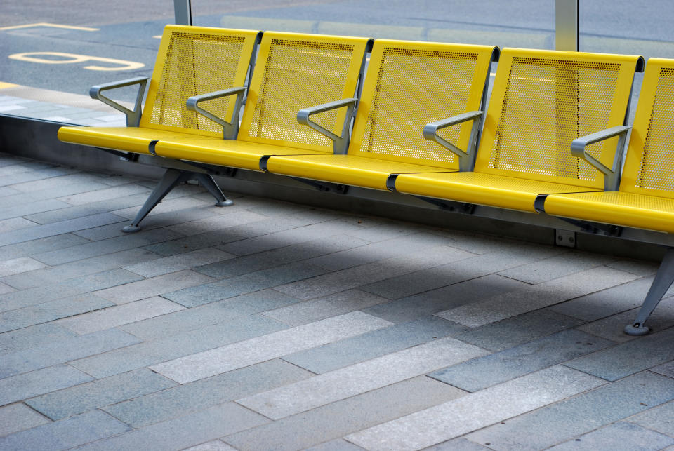 an empty bus stop with chairs