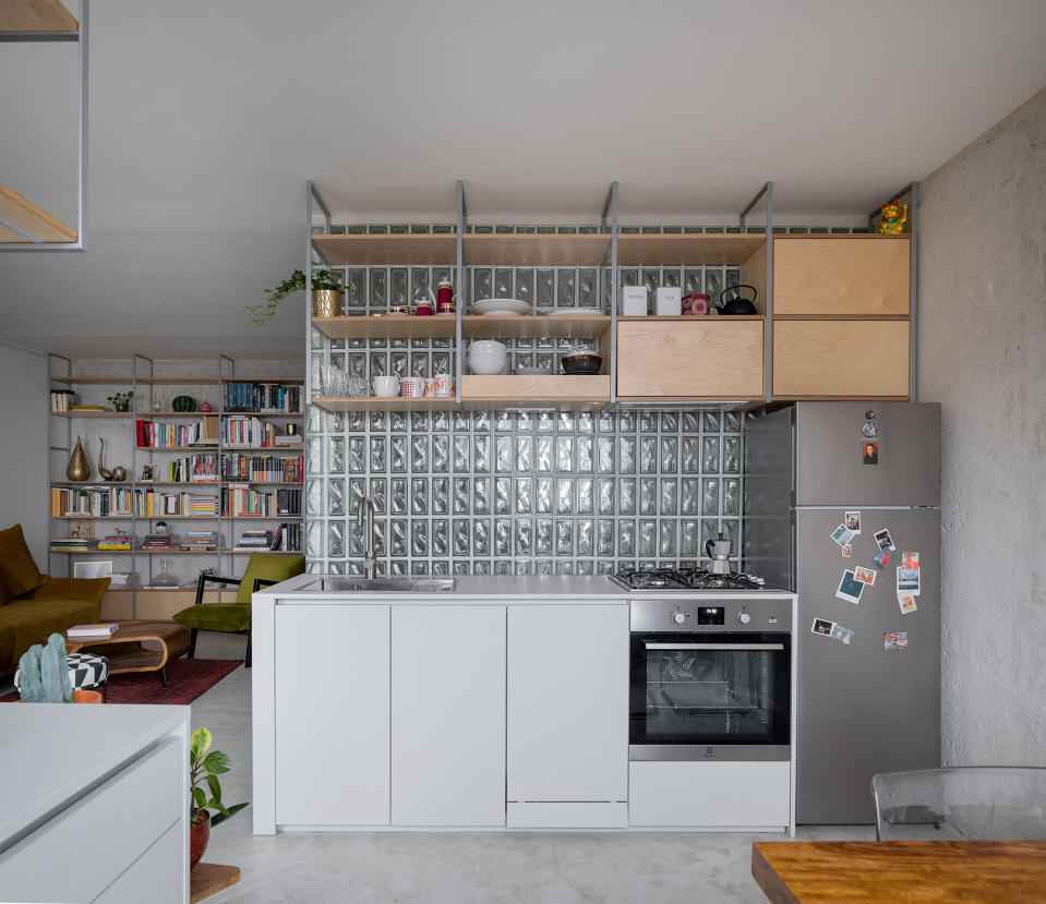 Apartment with curved glass wall running through