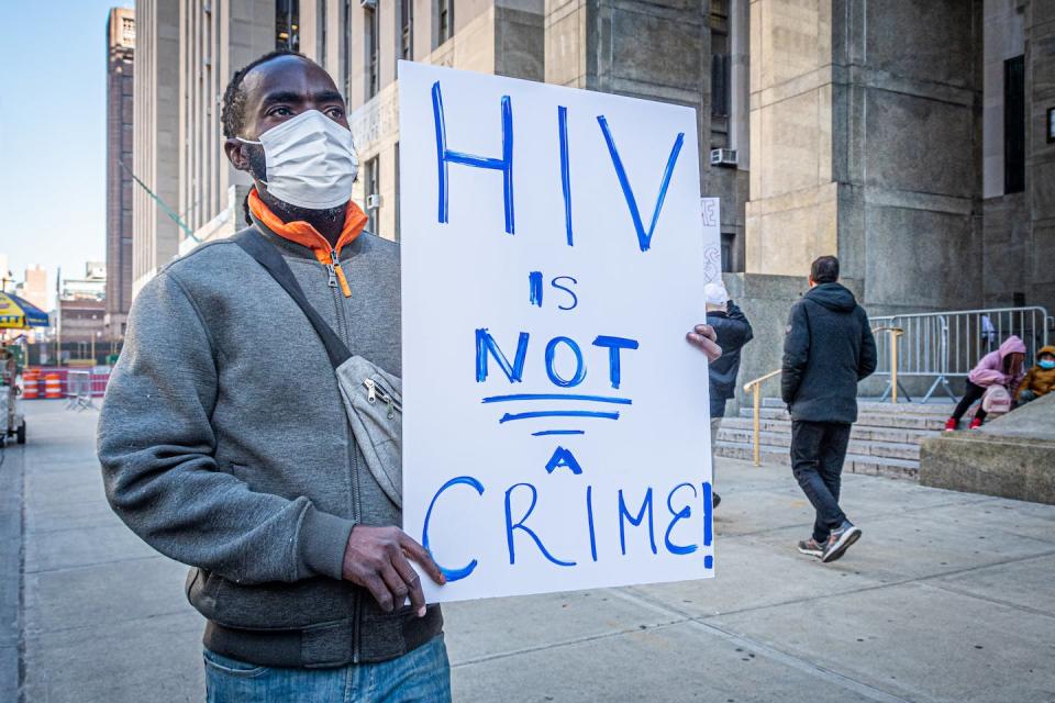 A member of the AIDS Coalition To Unleash Power protests against stigmatizing people who tested positive for HIV. <a href="https://www.gettyimages.com/detail/news-photo/participant-seen-holding-a-sign-at-the-protest-members-of-news-photo/1244646063?adppopup=true" rel="nofollow noopener" target="_blank" data-ylk="slk:Erik McGregor/LightRocket via Getty Images;elm:context_link;itc:0;sec:content-canvas" class="link ">Erik McGregor/LightRocket via Getty Images</a>