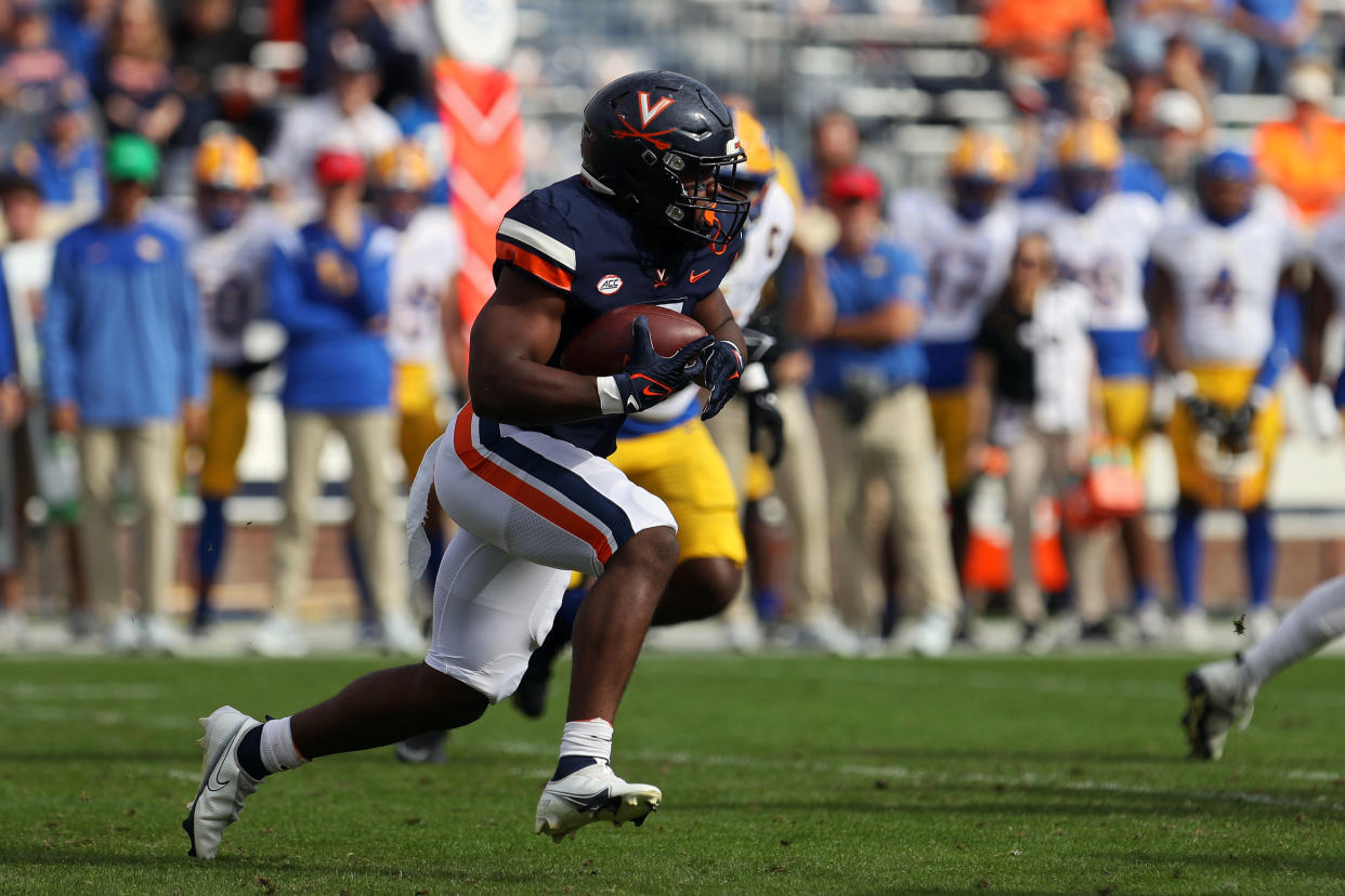 CHARLOTTESVILLE, VA - NOVEMBER 12: Mike Hollins #7 of the Virginia Cavaliers rushes in the first half during a game at Scott Stadium on November 12, 2022 in Charlottesville, Virginia. (Photo by Ryan M. Kelly/Getty Images)