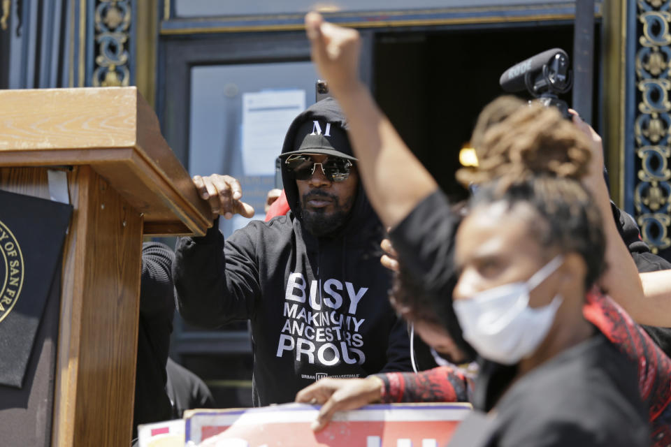 Jamie Foxx takes part in a "Kneel-In" to protest police racism on the steps of City Hall, Monday, June 1, 2020, in San Francisco. Hundreds watched the noon time demonstration. (AP Photo/Eric Risberg)