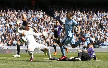 Football - Manchester City v West Ham United - Barclays Premier League - Etihad Stadium - 19/4/15 Manchester City's Sergio Aguero has his shot saved by West Ham's Adrian Reuters / Phil Noble