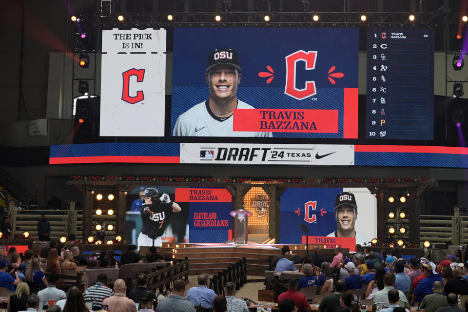 An image of Travis Bazzana is shown on the video board after the Cleveland Guardians selected Bazzana, the first overall pick in the MLB baseball draft, in Fort Worth, Texas, Sunday, July 14, 2024. (AP Photo/LM Otero)