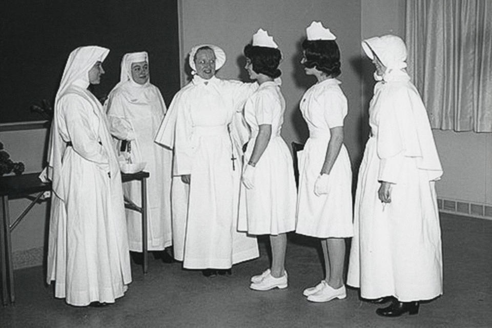 In this photo provided by the Sisters of Charity, new nursing graduates participate in a capping and tea ceremony at St. Vincent's School of Nursing on the Staten Island borough of New York, on Jan. 4, 1963. In more than 200 years of service, the Sisters of Charity of New York have cared for orphans, taught children, nursed the Civil War wounded and joined Civil Rights demonstrations. Last week, the Catholic nuns decided that it will no longer accept new members in the United States and will accept the "path of completion." (Sisters of Charity via AP)