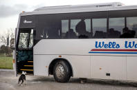 CORRECTS LAST NAME - Joe Watkins, 15, boards his school bus as his dog, Ellie, stands by the door near their home in Black River, Tasmania, Australia, Wednesday, July 24, 2019. One day, Watkins’ mom scrawled her anguish on a tattered envelope. "Imagine having a toothache for weeks, months 1 year, 2 years, 3, 4, and it's still aching now ... the pain eats away at you, the drugs send you crazy," she wrote. "Even the kids don't know their real mum." (AP Photo/David Goldman)