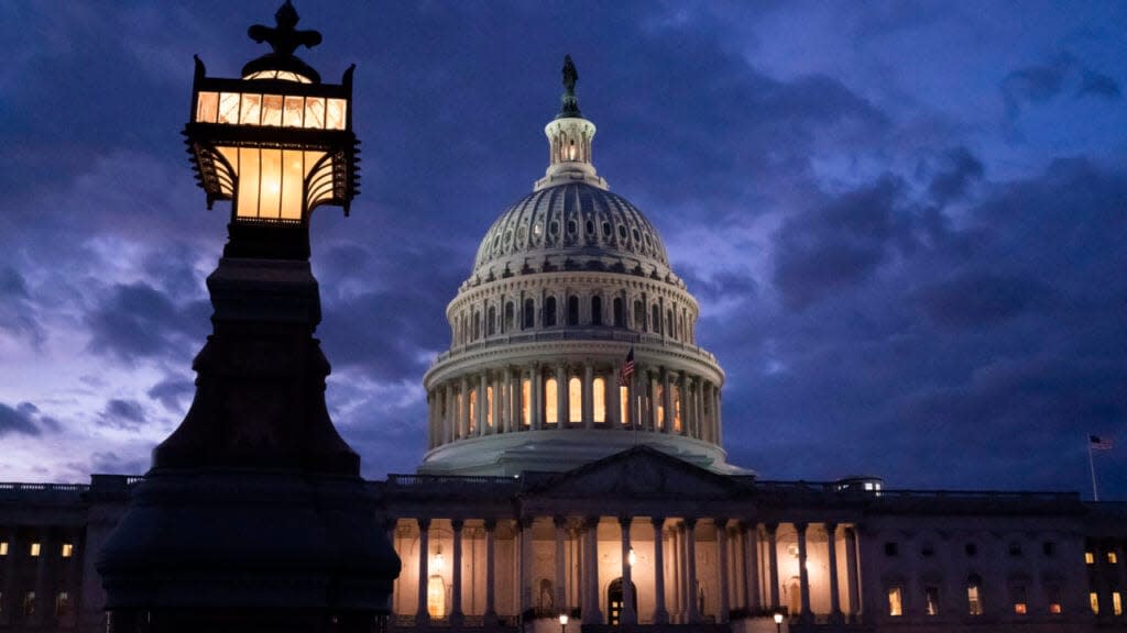 Night falls at the the Capitol in Washington, Thursday, Dec. 2, 2021, with the deadline to fund the government approaching. Republicans in the Senate are poised to stall a must-pass funding bill as they force a debate on rolling back the Biden administration’s COVID-19 vaccine mandates for some workers. (AP Photo/J. Scott Applewhite)