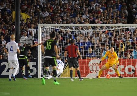 October 10, 2015; Pasadena, CA, USA; Mexico forward Oribe Peralta (19) scores a goal against USA goalkeeper Brad Guzan (1) during extra time of the CONCACAF Cup at Rose Bowl. Mandatory Credit: Gary A. Vasquez-USA TODAY Sports