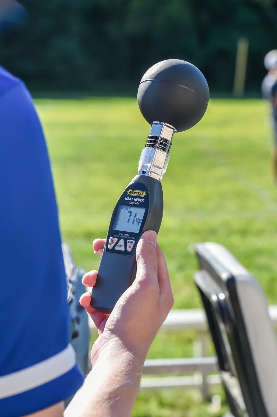 Always mindful of the late summer conditions, Milton's trainer checks the wet bulb temperature before the first day of practice for Milton football on Aug. 15, 2022.