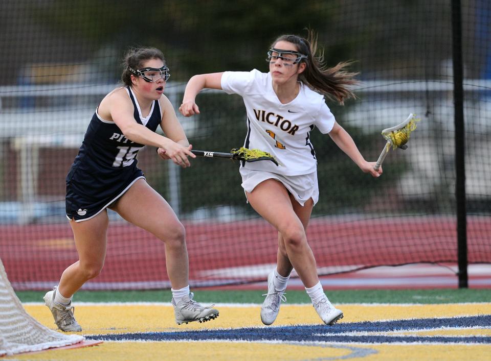 Victor's Eva Pronti is pressured by Pittsford's Caitlin Bergin.