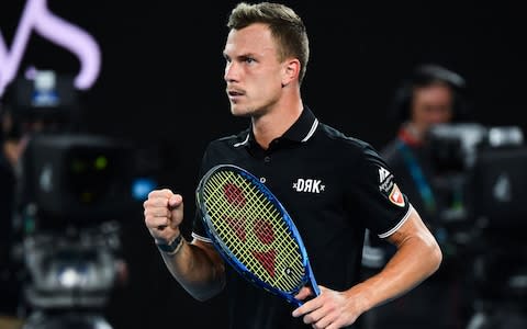 ungary's Marton Fucsovics reacts after a point against Switzerland's Roger Federer during their men's singles match on day seven of the Australian Open tennis tournament in Melbourne on January 26, 2020