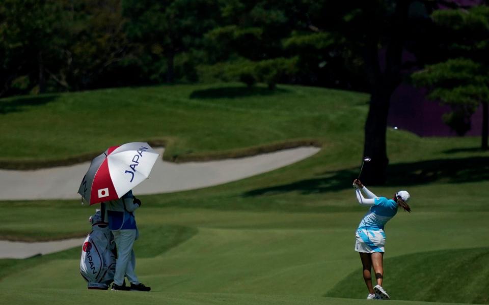 Mone Inami, of Japan,plays a shot from the 14th fairway during the third round of the women's golf event at the 2020 Summer Olympics. - AP Photo/Matt York