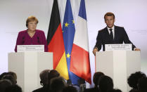 German Chancellor Angela Merkel, left, and French President Emmanuel Macron attend a media conference after joint Franco-German cabinet meeting in the government building of Toulouse, southwestern France, Wednesday, Oct.16, 2019. President Emmanuel Macron and Chancellor Angela Merkel sought Wednesday to demonstrate the solidity of the French-German relationship at a meeting in southern France, one day before a key EU summit that may approve a divorce deal with Britain.(AP Photo/Frederic Scheiber)