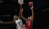 United States' A'Ja Wilson (9), right, shoots over Nigeria's Victoria Macaulay (25) during women's basketball preliminary round game at the 2020 Summer Olympics, Tuesday, July 27, 2021, in Saitama, Japan. (AP Photo/Eric Gay)