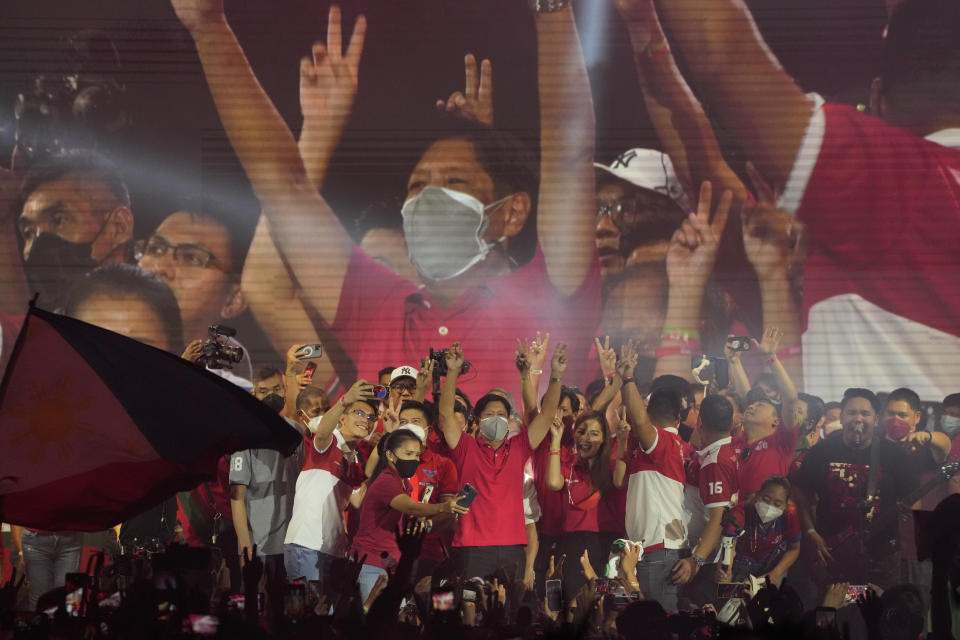 Presidential hopeful, former senator Ferdinand "Bongbong" Marcos Jr., the son of the late dictator, greets to the crowd during a campaign rally in Quezon City, Philippines on April 13, 2022. The winner of May 9, Monday's vote will inherit a sagging economy, poverty and deep divisions, as well as calls to prosecute outgoing leader Rodrigo Duterte for thousands of deaths as part of a crackdown on illegal drugs. (AP Photo/Aaron Favila)