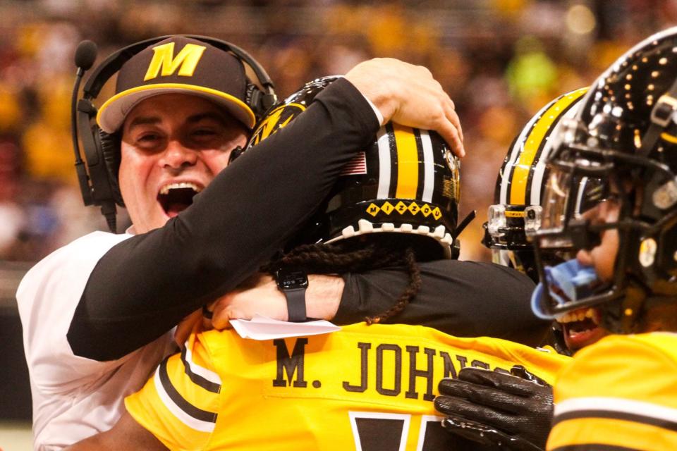 Missouri receivers coach Jacob Peeler hugs freshman receiver Marquis Johnson after Johnson's 76-yard touchdown catch during MU's game against Memphis in the Dome at America's Center on Sept. 23, 2023, in St. Louis.