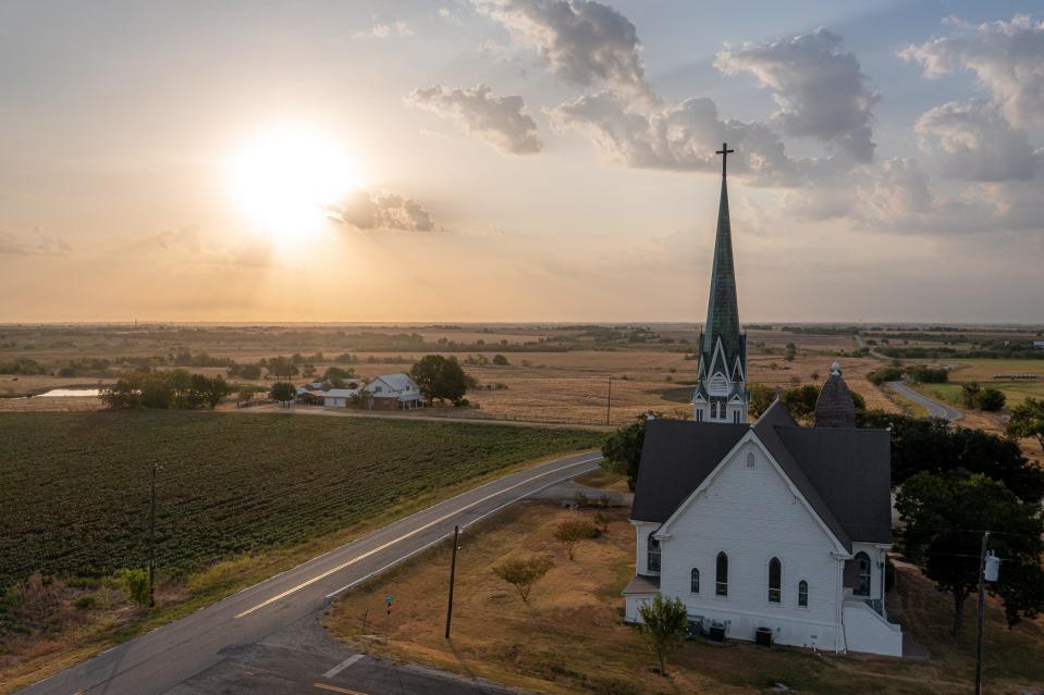 The sun rises behind the New Sweden Evangelical Lutheran Church on Aug. 20, 2023 in New Sweden, Texas. Swedish immigrants settled much of eastern Travis and Williamson counties.