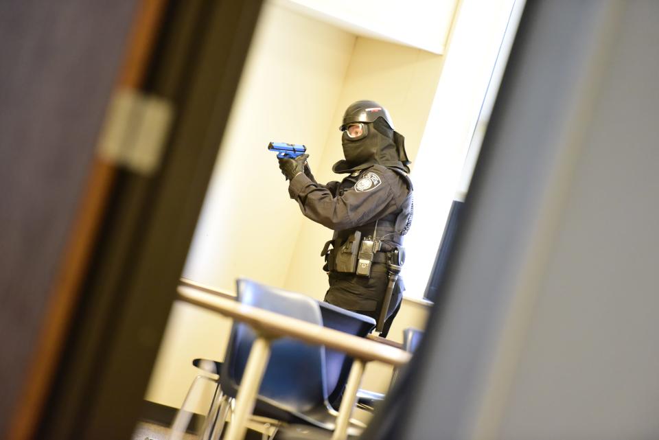 A Port Huron Police Department officer clears a room for an active shooter during the active killer training on the campus of St. Clair County Community College in Port Huron on Tuesday, August 9, 2022. Participating agencies include the police department, Detroit Homeland Security, U.S. Customs and Border Protection Air Marine, the Port Huron Fire Department, Tri-Hospital EMS, SC4 security personnel, St. Clair County Homeland Security and Emergency Management, McLaren Port Huron Hospital, Lake Huron Medical Center, and some surrounding area fire departments.
