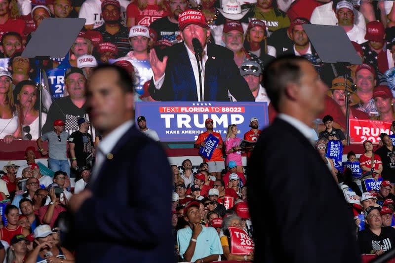 U.S. Secret Service agents watch as an image of Republican presidential candidate former President Donald Trump is shown on a screen at a campaign rally at Trump National Doral Miami, Tuesday, July 9, 2024, in Doral, Fla. | Rebecca Blackwell