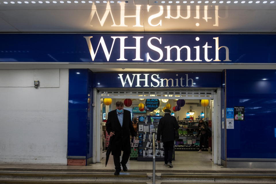 A person wearing a mask exits a branch of WH Smith in London, Britain, December 1, 2021. Picture taken December 1, 2021. REUTERS/May James