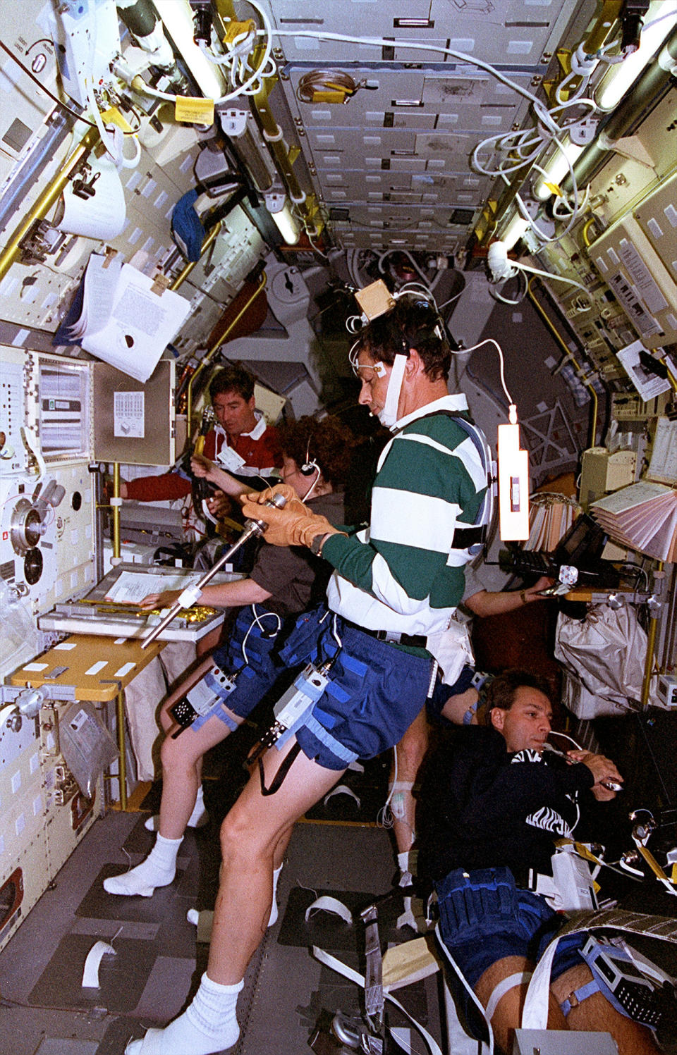 STS-78 payload specialist Jean-Jacques Favier, representing the French space agency CNES, prepares a sample for the Advanced Gradient Heating Facility while wearing instruments that measure upper body movement inside the Spacelab module on board space shuttle Columbia in July 1996.