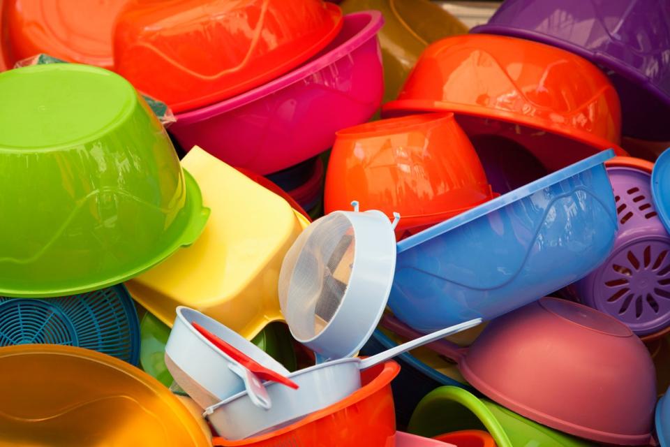 A pile of colorful plastic food and tupperware containers. 