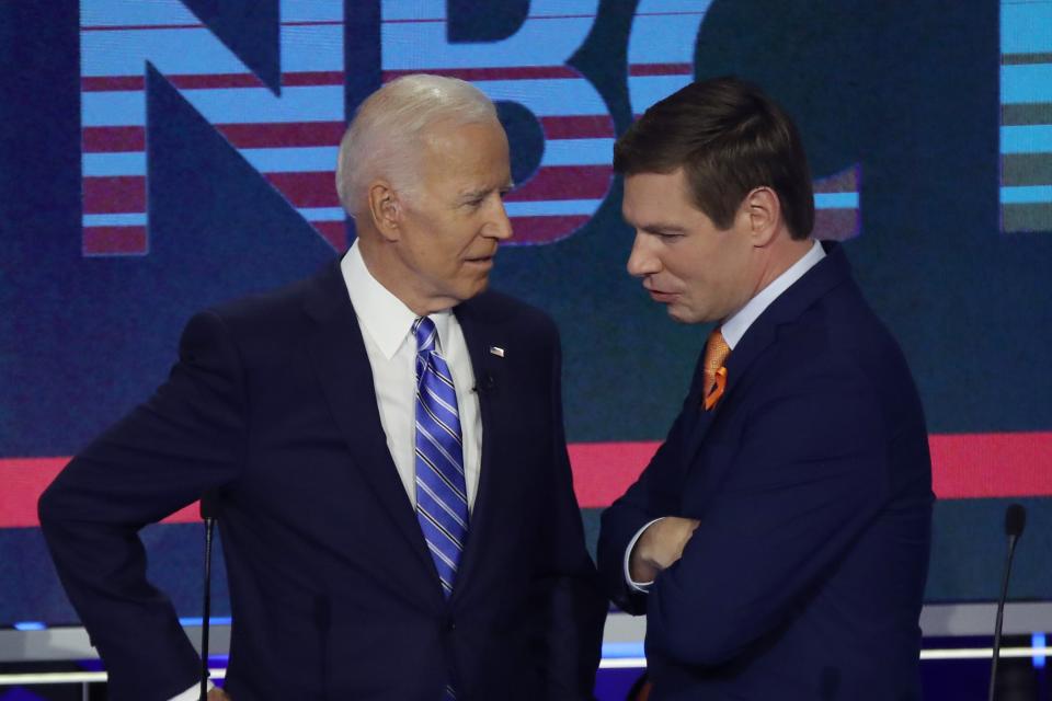Former Vice President Joe Biden and Rep. Eric Swalwell, D-Calif., speak during a break in the second night of the first Democratic presidential debate on June 27, 2019 in Miami, Florida.