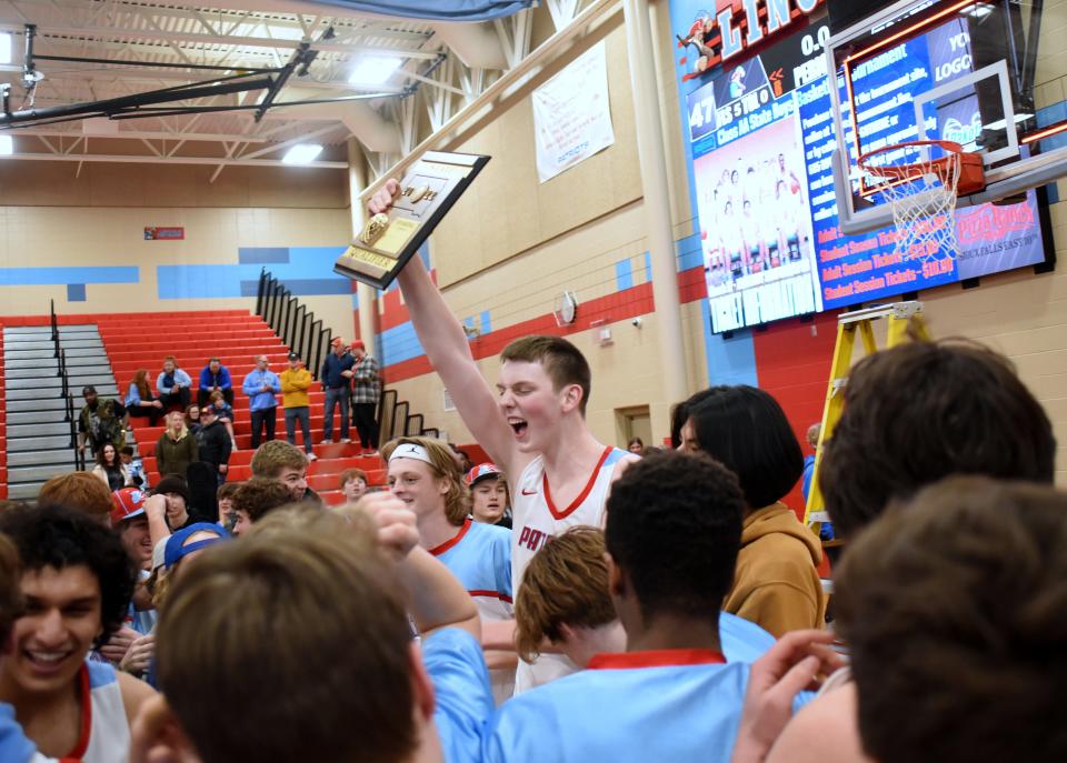 Sioux Falls Lincoln’s JT Rock holds up the trophy after the Patriots defeated Brandon Valley 47-40 in a SoDak 16 game Saturday, March 5, in Sioux Falls.