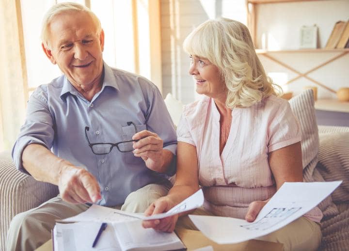 A couple sitting in their living room discussing the value of financial advice