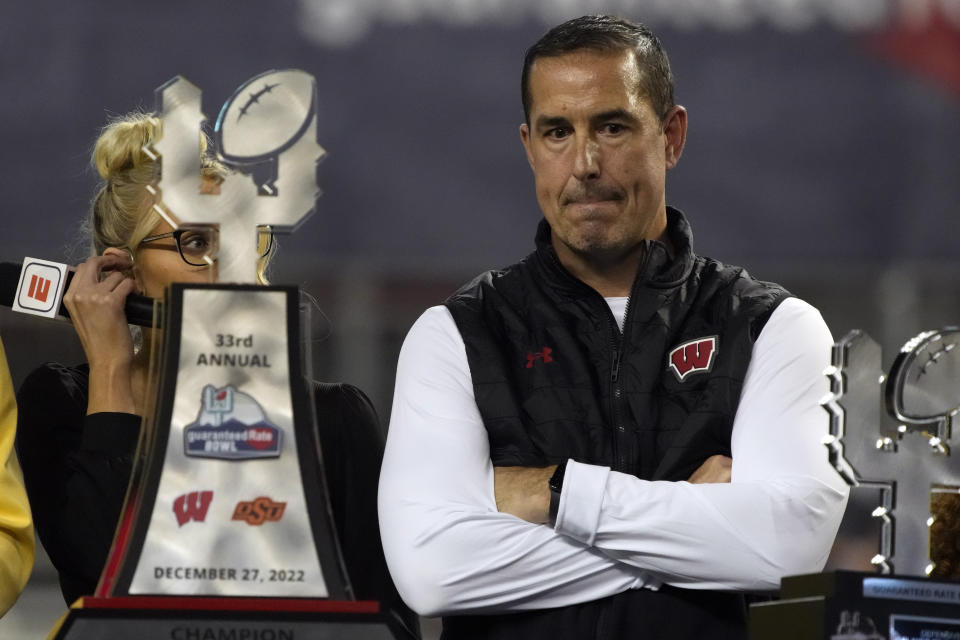 Wisconsin head coach Luke Fickell stands with the trophy after defeating Oklahoma State 24-17 in the Guaranteed Rate Bowl NCAA college football game Tuesday, Dec. 27, 2022, in Phoenix. (AP Photo/Rick Scuteri)