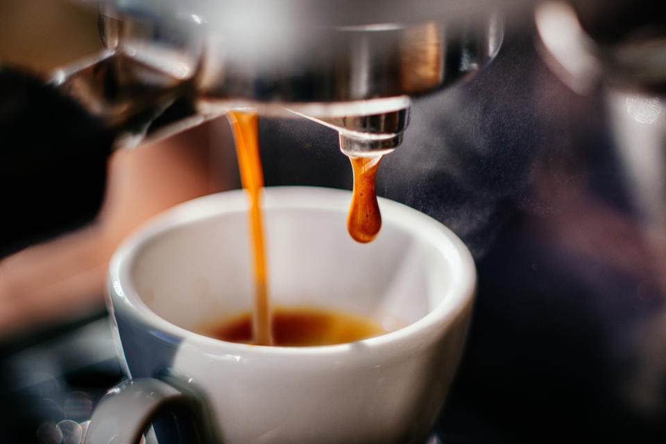 Fresh espresso shot pouring out of machine.