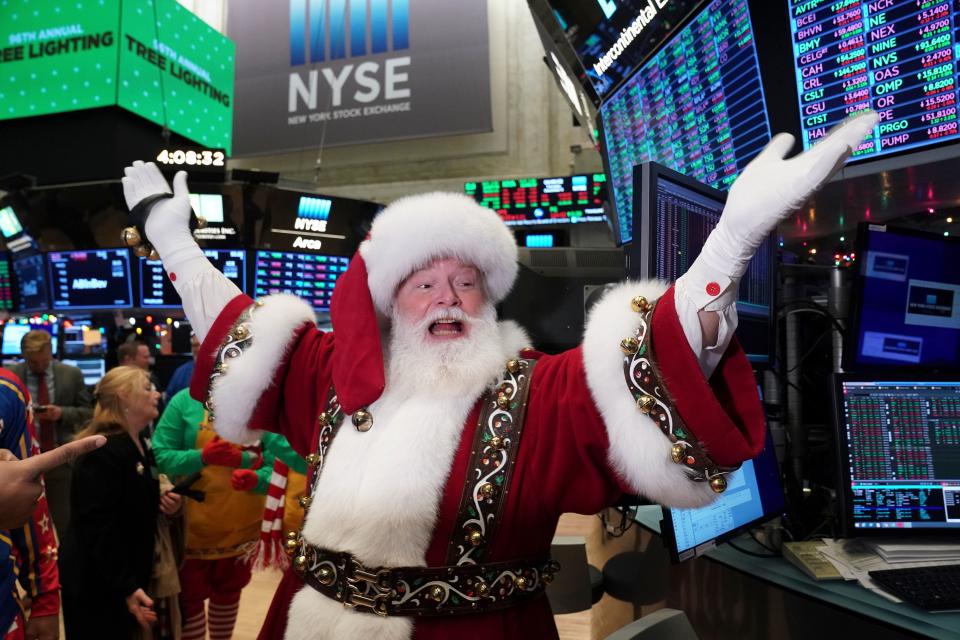 Santa Clause gestures on the floor at the closing bell of the Dow Industrial Average at the New York Stock Exchange on December 5, 2019 in New York. - Wall Street stocks finished slightly higher  following a choppy session that avoided the big swings from earlier in the week on trade-oriented headlines. US and Chinese negotiators are working to finalize a preliminary trade deal announced in October that would block new tariffs expected to take effect this month. Officials have sent mixed signals on the talks, sending shares gyrating. (Photo by Bryan R. Smith / AFP) (Photo by BRYAN R. SMITH/AFP via Getty Images)