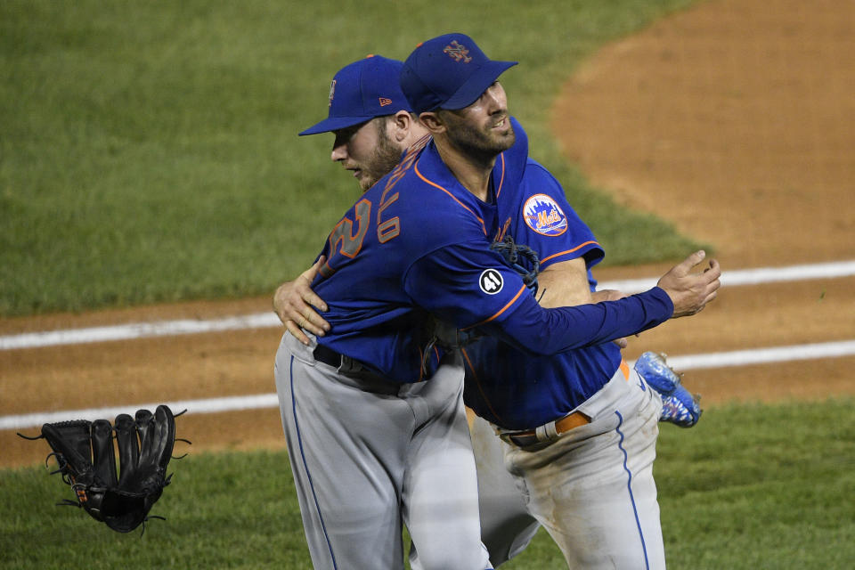 New York Mets first baseman Pete Alonso, back, and Rick Porcello, front, collide while trying to make a play as Washington Nationals' Luis Garcia reached first on a fielding error by Alonso during the third inning of the second baseball game of a doubleheader, Saturday, Sept. 26, 2020, in Washington. (AP Photo/Nick Wass)