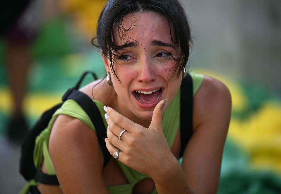 A fan of Brazil cries after watching the live broadcast of the Qatar 2022 World Cup Quarter-final round football match between Brazil and Croatia in Rio de Janeiro, Brazil, on December 9, 2022. (Photo by CARL DE SOUZA / AFP) (Photo by CARL DE SOUZA/AFP via Getty Images)