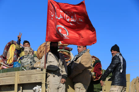 Iraqi army members ride in a military vehicle in Bartila, Iraq December 7, 2016. REUTERS/Alaa Al-Marjani