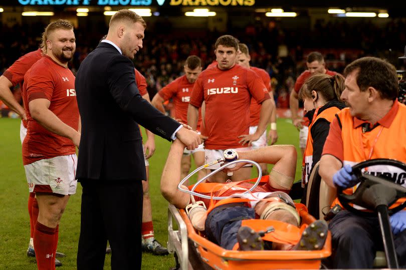 Wales players shake hands with Ellis Jenkins as he is stretchered from the field -Credit:Ben Evans/Huw Evans Agency