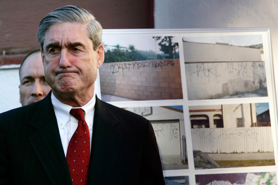 <p>FBI Director Robert Mueller grimaces while listening to Los Angeles Mayor Antonio Villaraigosa speaking of the death of Cheryl Green, during a news conference announcing anti-gang measures, Thursday Jan. 18, 2007 in Wilmington, Calif. Authorities announced Thursday an offensive against the Hispanic gang allegedly behind the racially charged shooting death of Cheryl Greenl, the first part of what they said will be a major crackdown on street gangs this year. In the background photos of the 204th Street gang graffiti. (Photo: Damian Dovarganes/AP) </p>